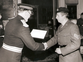 LORD LT of CORNWALL LORD FALMOUTH presenting CPL MICHAEL (NOBBY) CLARKE WITH HIS TA SERVICE CERTIFICATE
